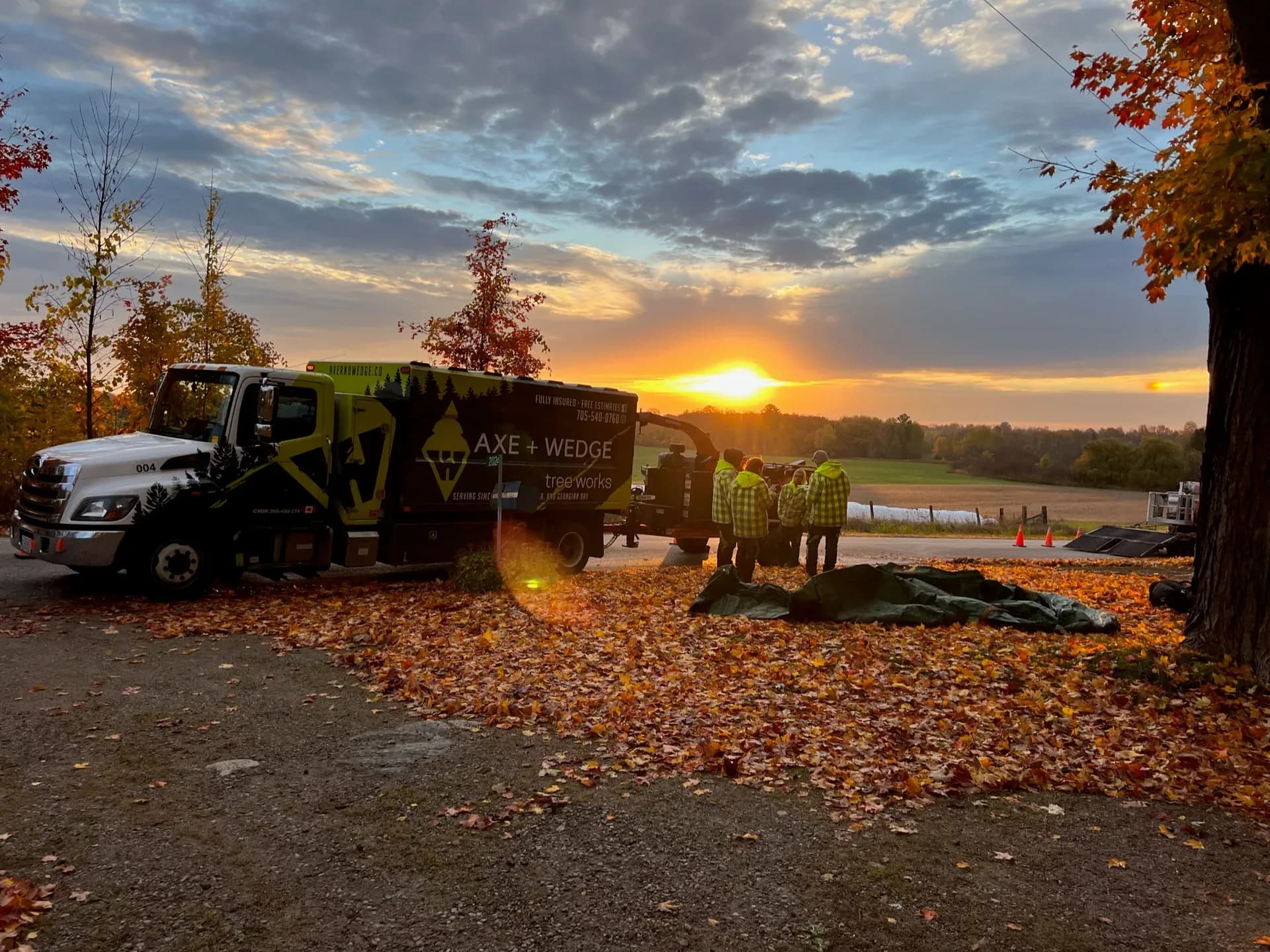 Axe & Wedge Tree Works crew wrapping up a job at sunset in Simcoe County